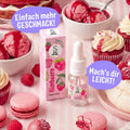 SuperAroma Himbeere – Backaroma Fläschchen umgeben von Macarons, Eis und Cupcakes